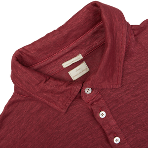 Close-up of a Massimo Alba Raspberry Red Linen Polo Shirt with a focus on the collar and label.