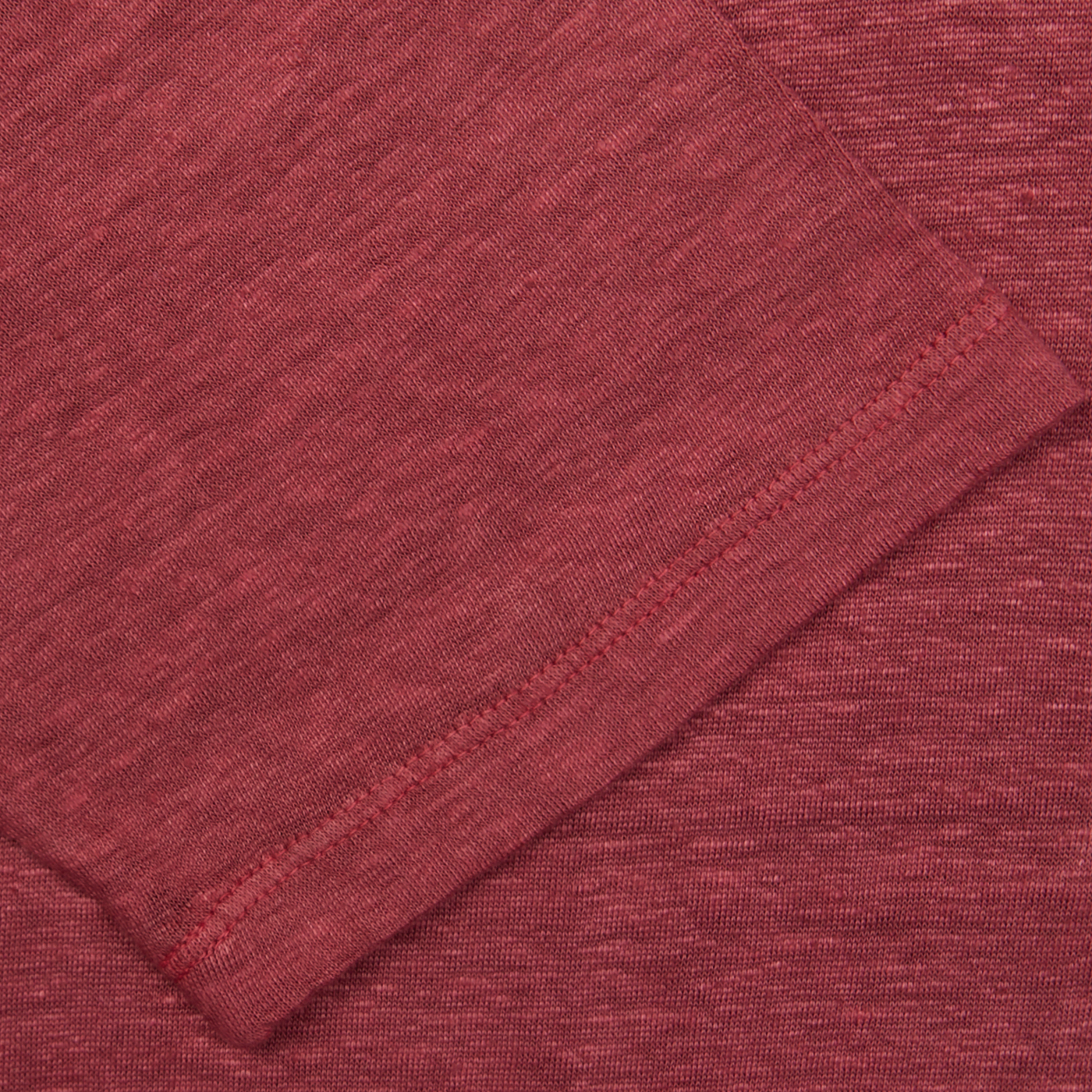 Close-up of a Massimo Alba Raspberry Red Linen Polo Shirt with a folded edge and visible stitching, dyed using natural chemical-free pigments.