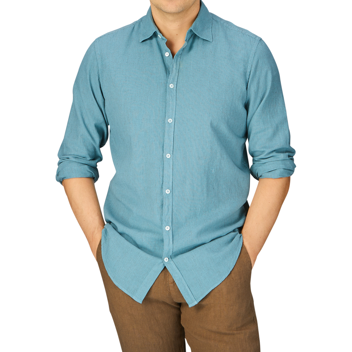 Man in a Massimo Alba Turquoise Striped Cotton Linen Genova Shirt, made in Italy, with sleeves rolled up, paired with brown trousers cropped at the mid-torso.