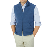 A man wearing a Maurizio Baldassari Denim Blue Milano Stitch Wool Zip Gilet and tan pants.