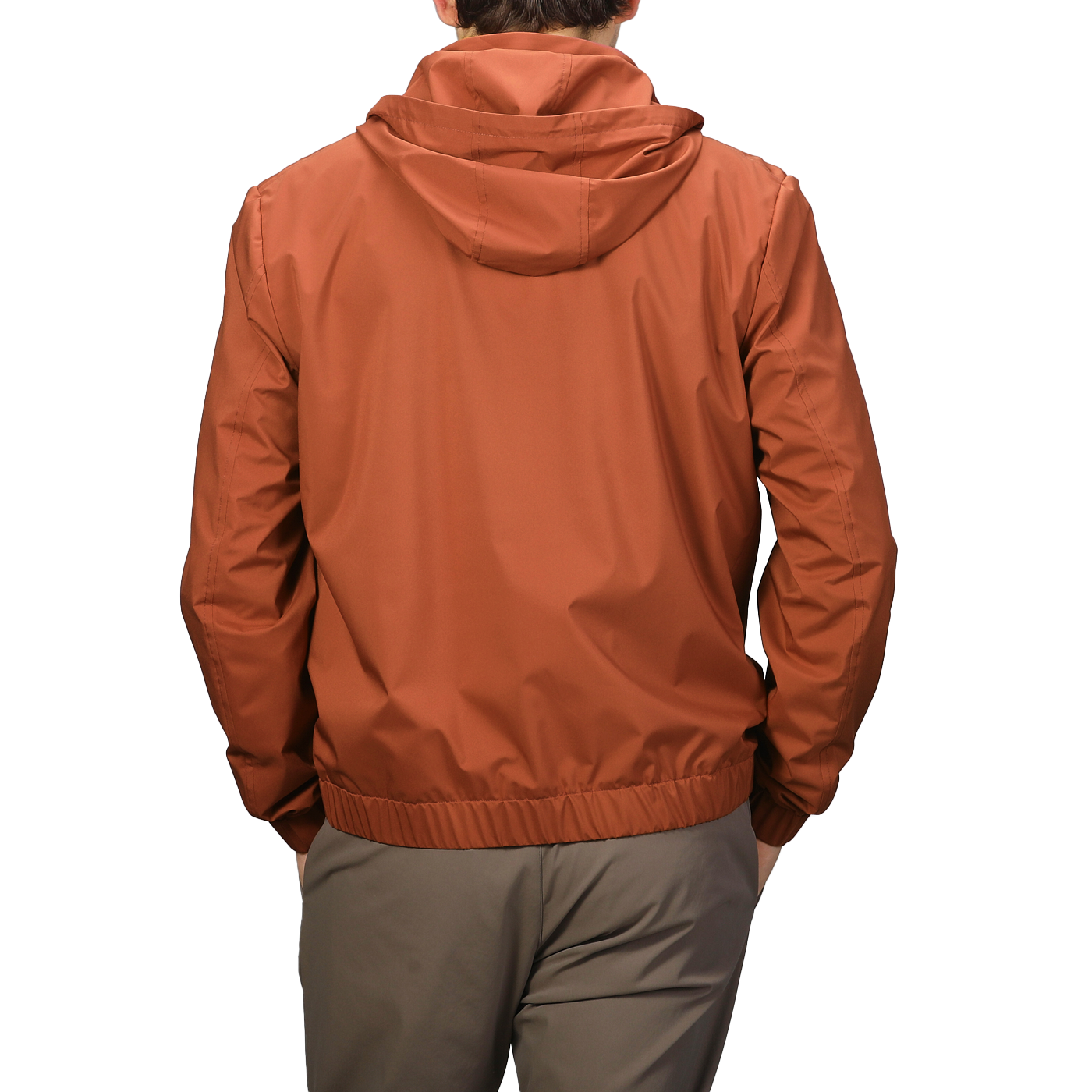 The individual is seen from the back wearing a Terracotta Brown Nylon Hooded Blouson Jacket by Maurizio Baldassari with khaki pants.