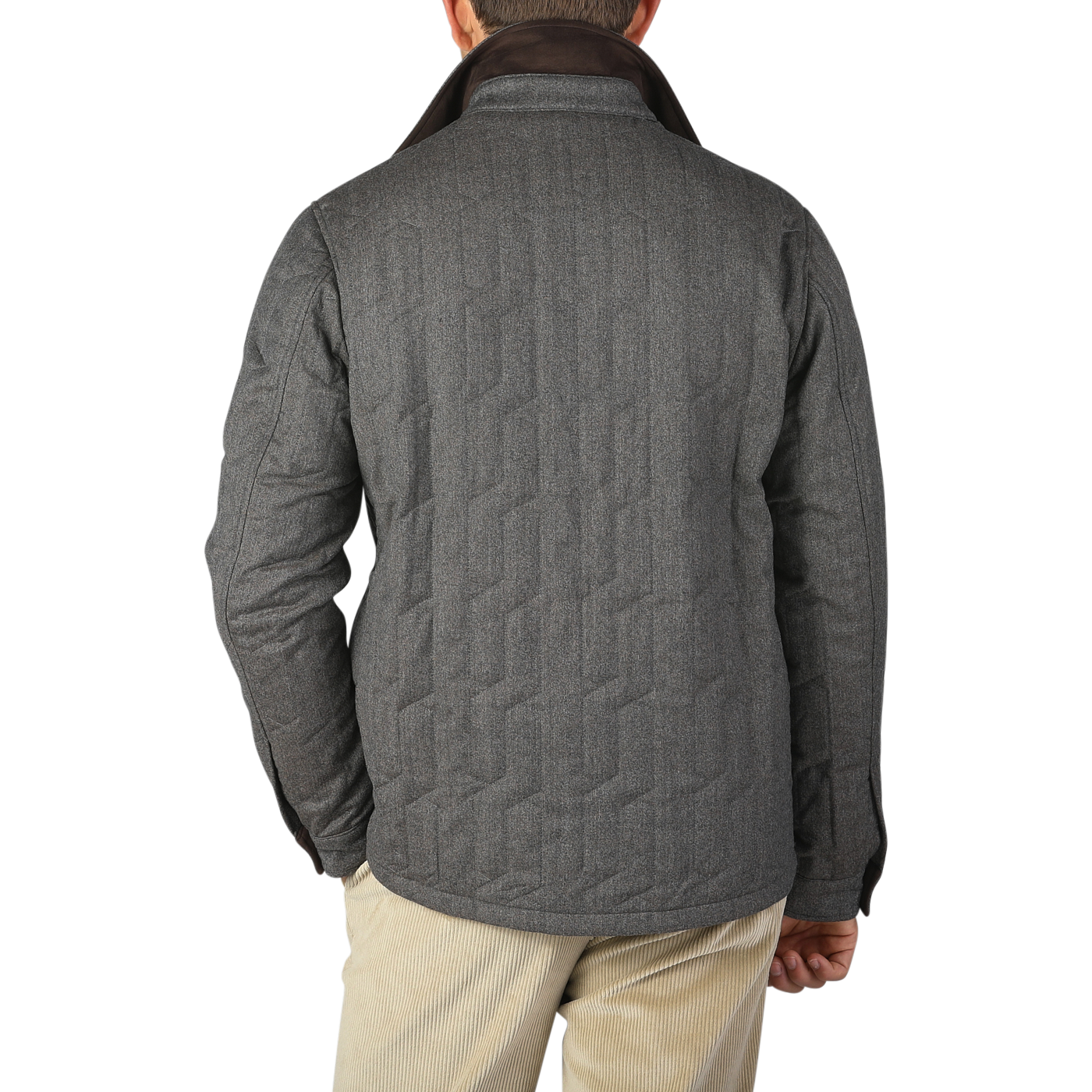 A person is standing with their back facing the camera, wearing a Taupe Beige Herringbone Quilted Virgin Wool Overshirt by Maurizio Baldassari and beige pants against a plain background.