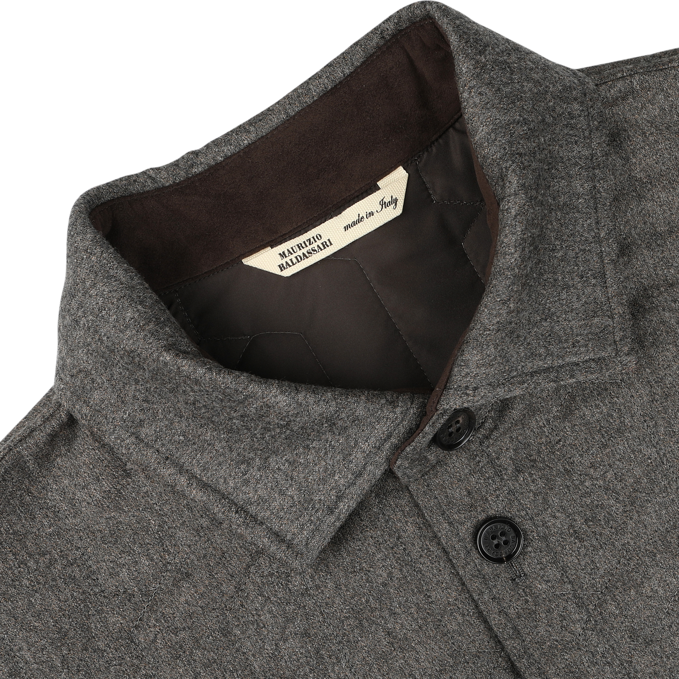 Close-up of a taupe beige herringbone quilted virgin wool overshirt collar with black buttons, showcasing a beige label inside that reads "Maurizio Baldassari made in Italy," and hinting at its subtle Thermore padding for added warmth.