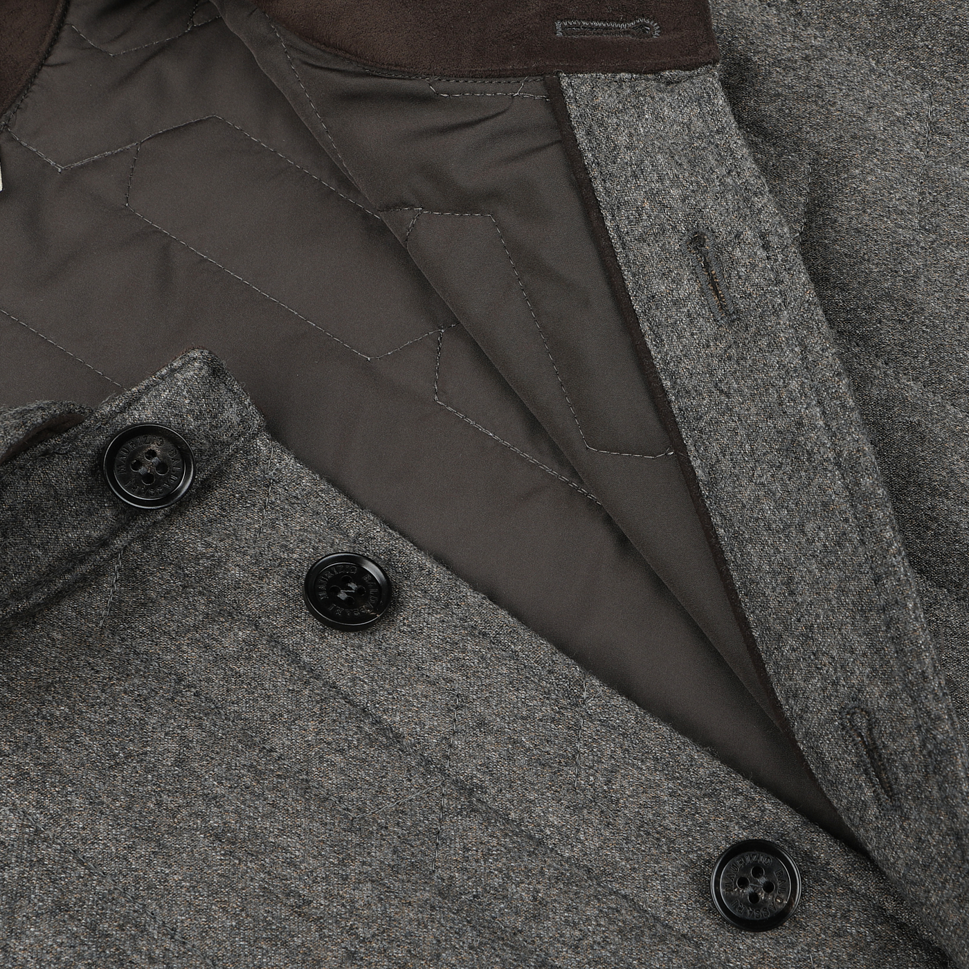 Close-up of a Taupe Beige Herringbone Quilted Virgin Wool Overshirt by Maurizio Baldassari, showcasing the interior quilting and button details. The dark grey lining complements Thermore padding, and the overshirt features sleek black buttons.