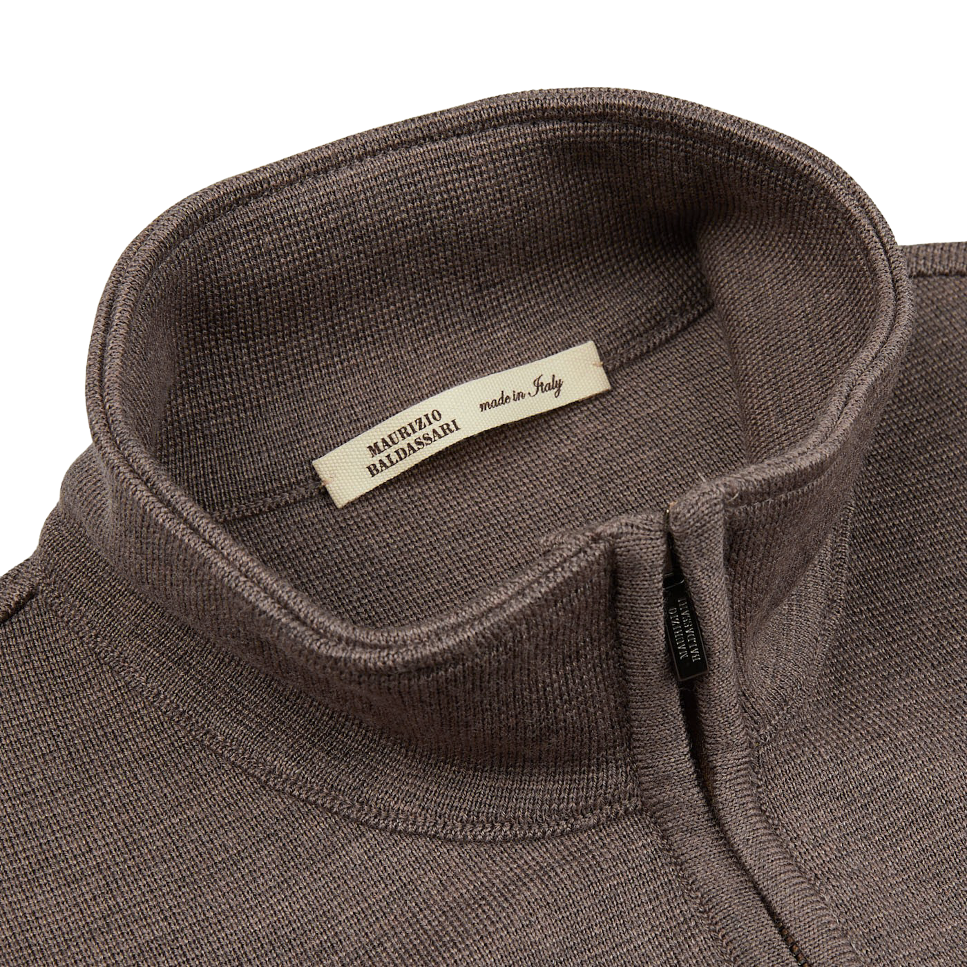 A close up of a Dark Beige Milano Stitch Wool Zip Gilet with a label on it, featuring the brand name "Maurizio Baldassari" and the keywords "Milano stitch".