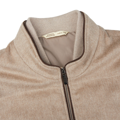 A Maurizio Baldassari Beige Water Repellent Pure Cashmere Gilet with a zipper on the front.