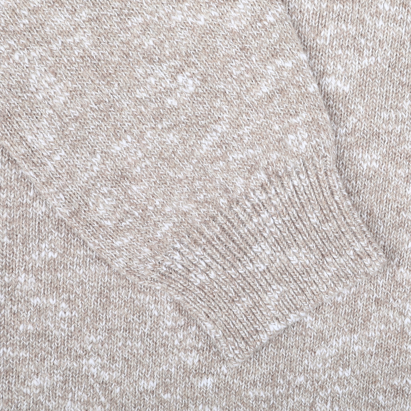 Close-up of the Beige Winter Wool Mouline 1/4 Zip Sweater sleeve by Maurizio Baldassari, showcasing the ribbed cuff detail of this soft wool-cotton blend piece.