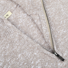 Close-up of a Beige Winter Wool Mouline 1/4-zip sweater by Maurizio Baldassari, crafted from a soft wool-cotton blend, with a visible brand tag on the inside collar. The zipper is partially open.