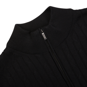 Close-up of a black Maurizio Baldassari Black Cotton Silk Cable-Knit 1/4 Zip Sweater with a partial zipper detail.