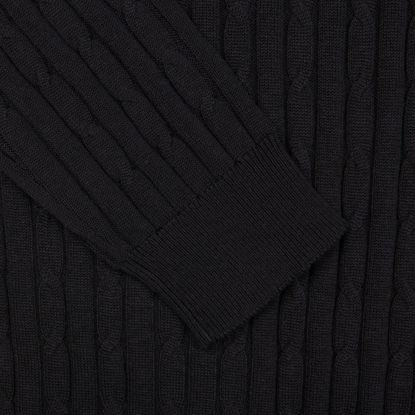 Close-up of a black Maurizio Baldassari Black Cotton Silk Cable-Knit 1/4 Zip Sweater with ribbed cuffs.