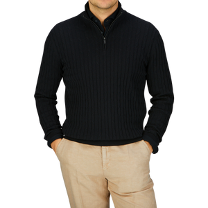 Man wearing a Black Cotton Silk Cable-Knit 1/4 Zip Sweater by Maurizio Baldassari and beige pants.