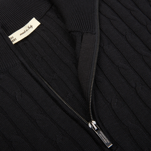 Close-up of a Maurizio Baldassari Black Cotton Silk Cable-Knit 1/4 Zip Sweater with a partial zipper and a Maurizio Baldassari label.