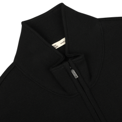 Close-up of the Black Milano Stitch Wool Zip Gilet by Maurizio Baldassari, featuring a high collar, a small manufacturer label near the collar, and crafted from virgin wool using Milano stitch.