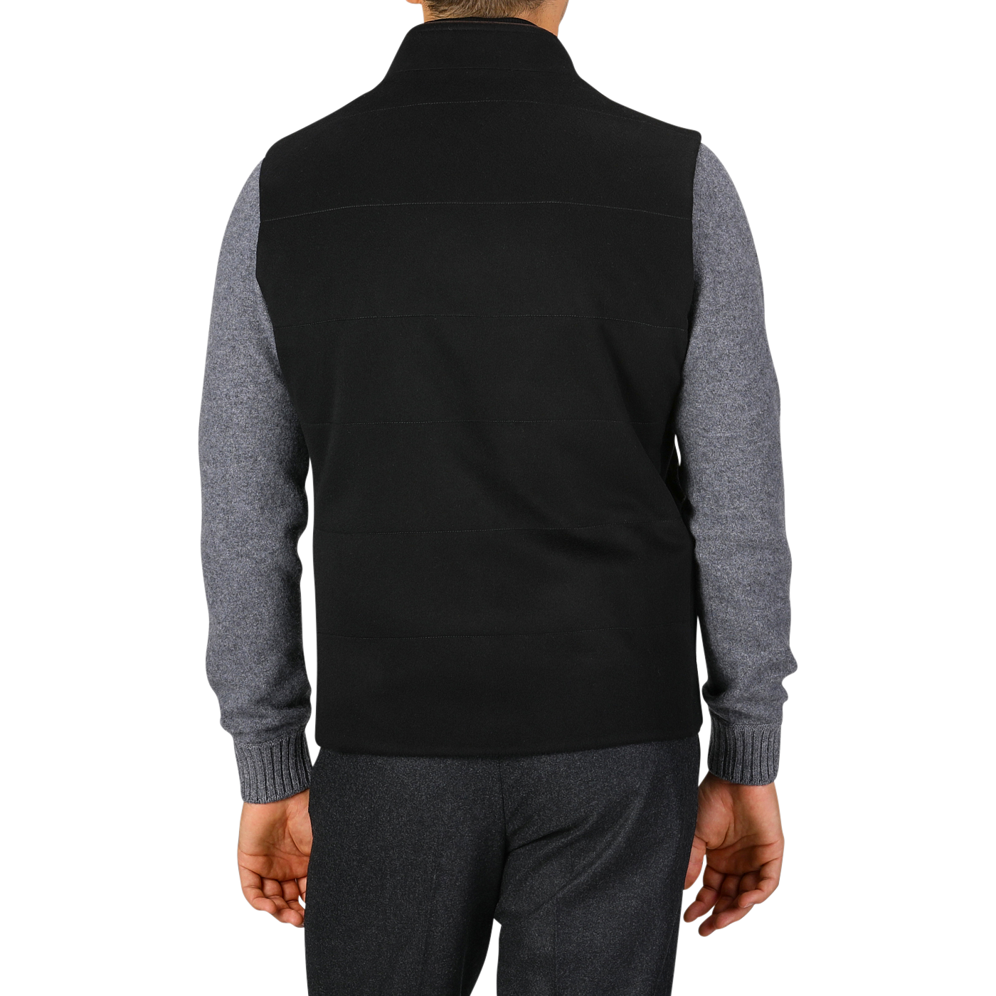 A rear view of a person wearing a Maurizio Baldassari Black Water Repellent Cashmere Gilet over a gray long-sleeve shirt and dark pants, standing against a white background.