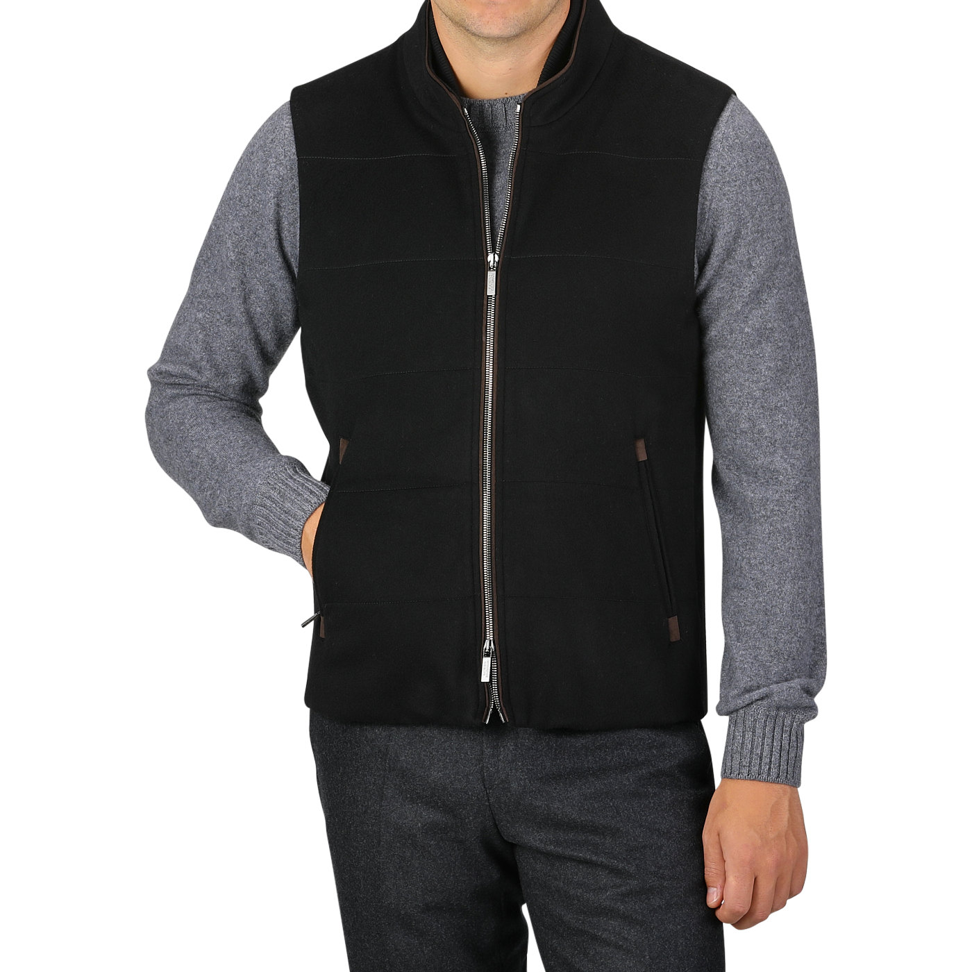 A person is wearing a Black Water Repellent Cashmere Gilet from Maurizio Baldassari over a gray long-sleeve shirt and dark pants. The gilet, featuring side pockets, adds a touch of sophistication as the person poses with one hand in a pocket.