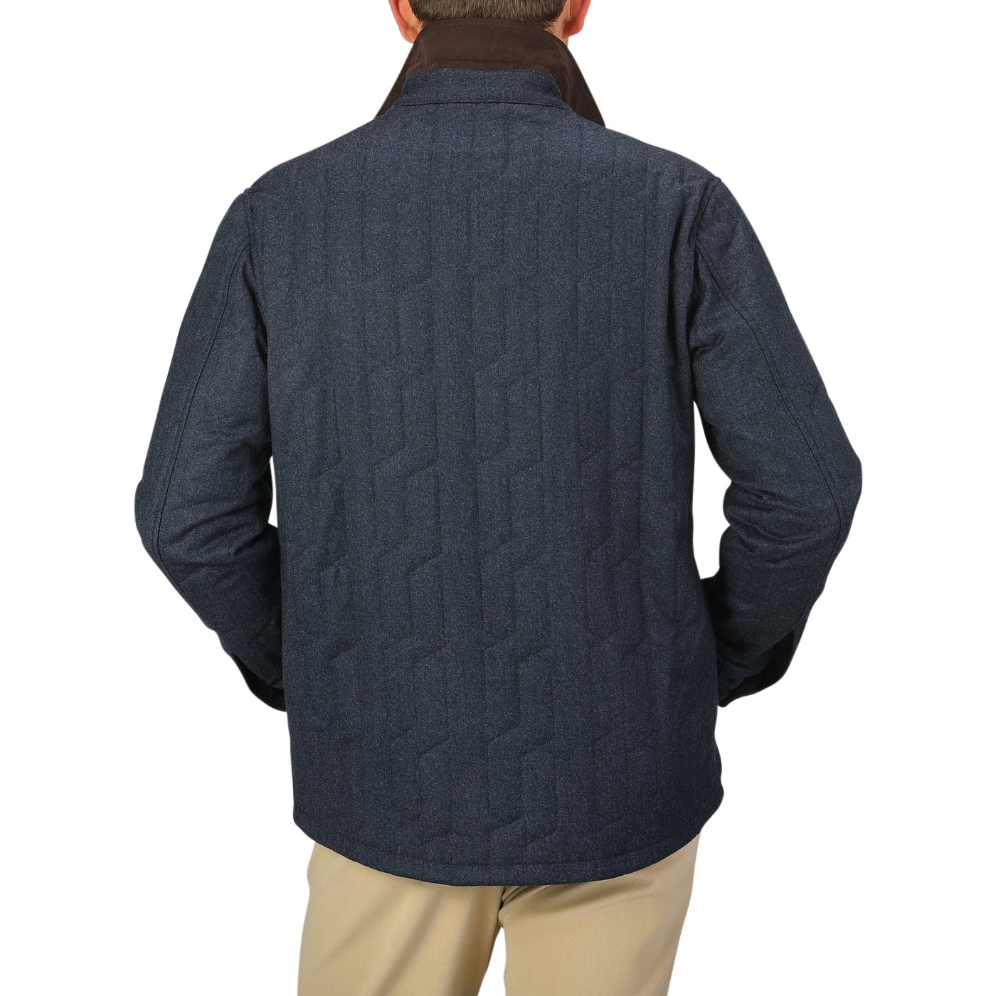 A person wearing a blue melange quilted virgin wool overshirt by Maurizio Baldassari, khaki pants, and a dark collar is seen from the back.