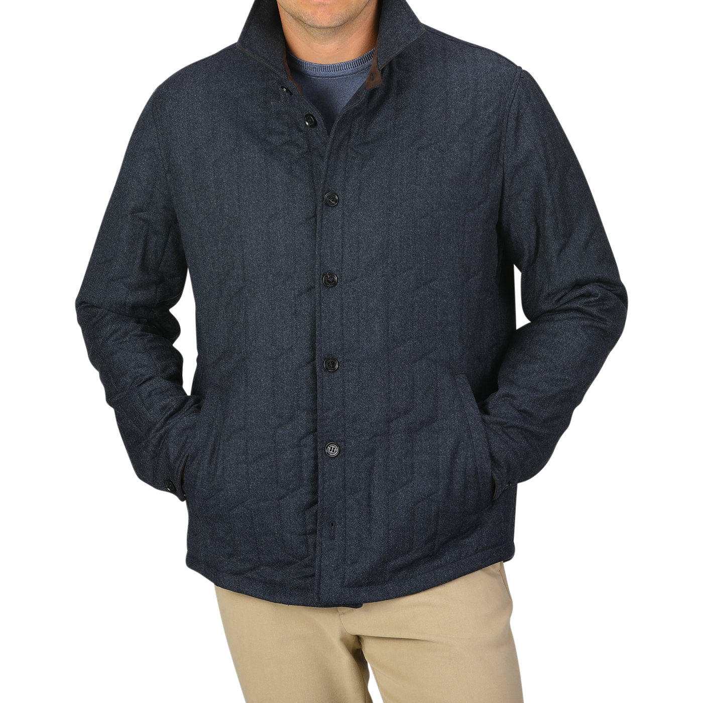 A person wearing the Blue Melange Quilted Virgin Wool Overshirt by Maurizio Baldassari with their hands in the pockets. The background is plain light gray.