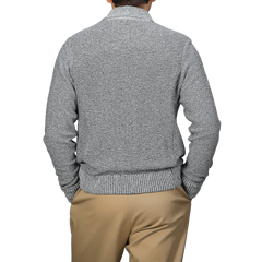 Back view of someone enjoying relaxed luxury, wearing a Maurizio Baldassari Blue Melange Summer Mouline Blouson with beige pants.