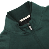 A bottle green cashmere zip blouson jacket from Maurizio Baldassari featuring a visible brand label inside the collar, reading "ALBINI DESIGN MILANO," and a smaller tag indicating it is made in Italy.