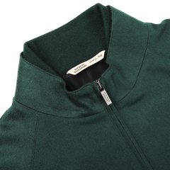 A bottle green cashmere zip blouson jacket from Maurizio Baldassari featuring a visible brand label inside the collar, reading "ALBINI DESIGN MILANO," and a smaller tag indicating it is made in Italy.