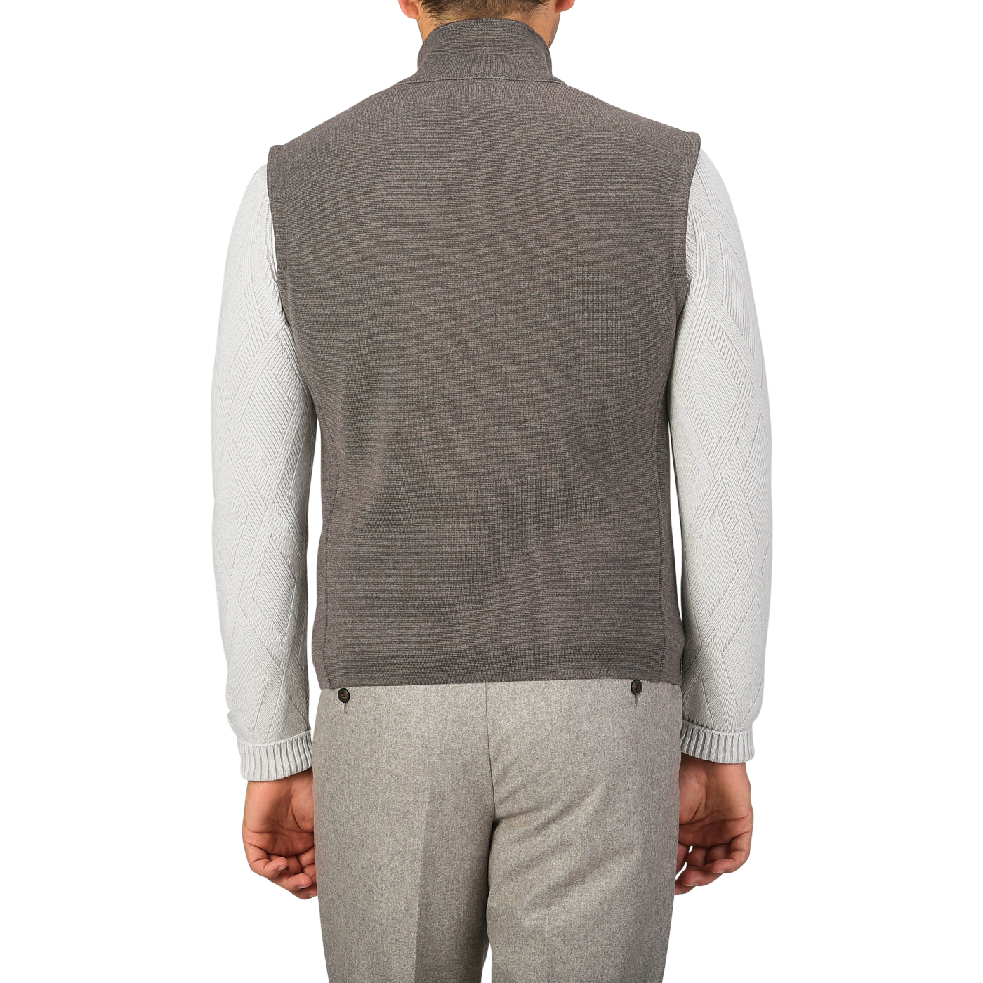 A person is seen from behind wearing the Brown Melange Milano Stitch Wool Zip Gilet by Maurizio Baldassari, a white long-sleeve shirt, and grey trousers made of pure virgin wool.