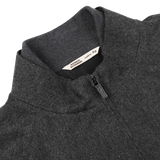 Close-up of the charcoal grey zip blouson collar, featuring a visible brand label inside that reads "Maurizio Baldassari Made in Italy.