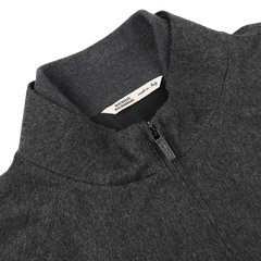 Close-up of the charcoal grey zip blouson collar, featuring a visible brand label inside that reads "Maurizio Baldassari Made in Italy.