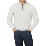 A man wearing a Maurizio Baldassari Cream White Cotton Mouline 1/4 Zip Sweater and jeans.