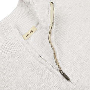 A close up of a Maurizio Baldassari Cream White Cotton Mouline 1/4 Zip Sweater with a zipper.