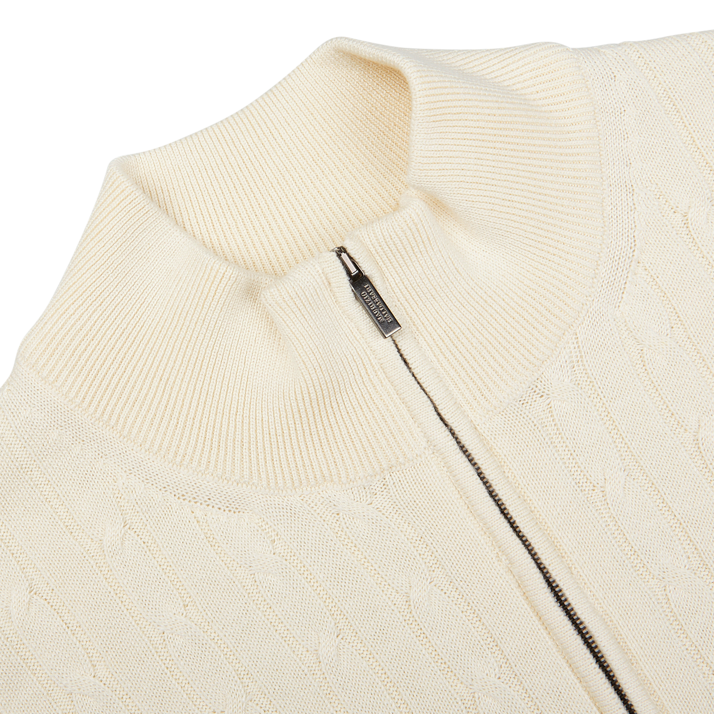 Close-up view of a Maurizio Baldassari Cream Cotton Silk Cable Knit 1/4 Zip Sweater with a zipper detail at the collar.