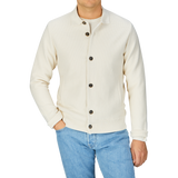 Man wearing a Maurizio Baldassari Cream Beige Silk Cotton Knitted Blouson and blue jeans.