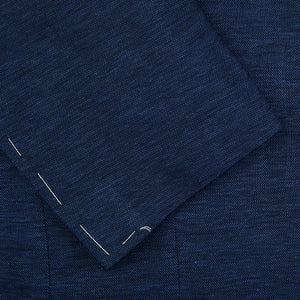 A close up of a Maurizio Baldassari Dark Blue Wool Linen Silk Jersey Blazer with white stitching.