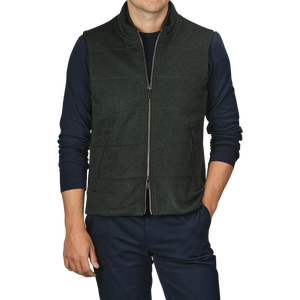 A person wearing a Maurizio Baldassari Dark Green Water Repellent Cashmere Gilet over a navy long-sleeve shirt with dark pants.