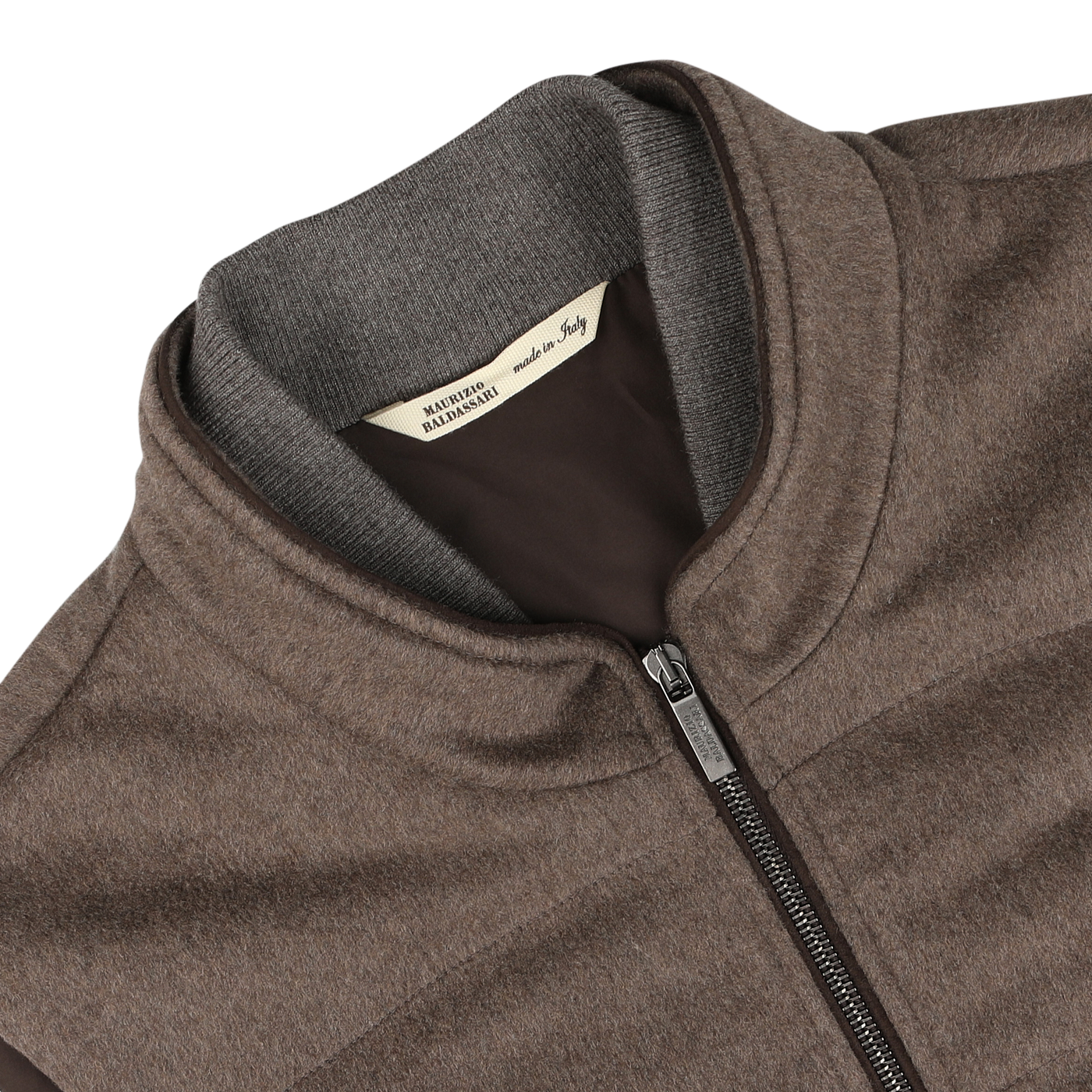 Close-up of a Dark Taupe Water Repellent Cashmere Gilet by Maurizio Baldassari, featuring a high collar and a label that reads "Made in Italy.