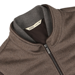 Close-up of a Dark Taupe Water Repellent Cashmere Gilet by Maurizio Baldassari, featuring a high collar and a label that reads "Made in Italy.