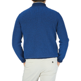 The back view of a man wearing a Maurizio Baldassari Denim Blue Cotton Mouline 1/4 Zip Sweater.