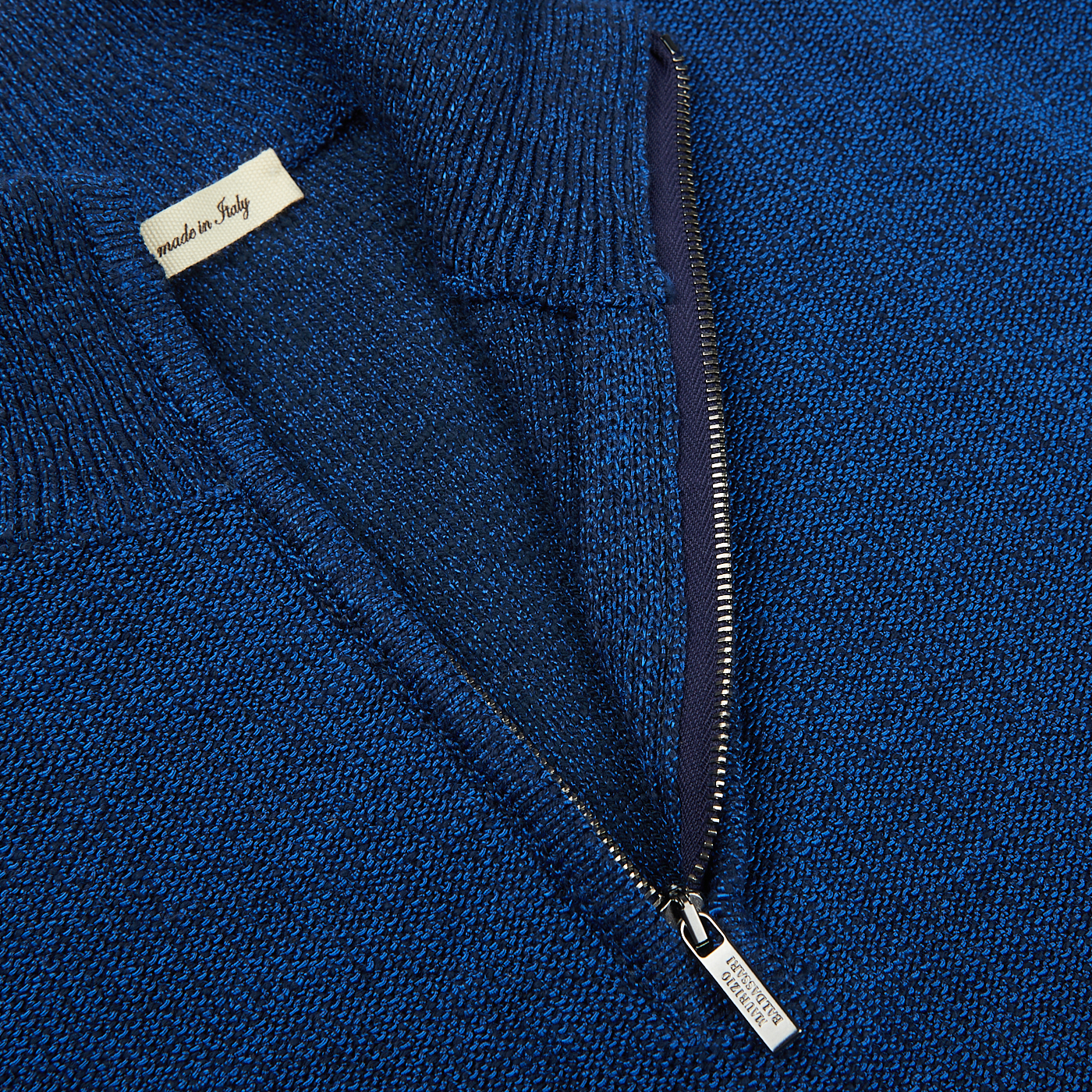 A close up of a Maurizio Baldassari Denim Blue Cotton Mouline 1/4 Zip Sweater.