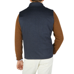 The back view of a man wearing a Maurizio Baldassari Denim Blue Water Repellent Pure Cashmere Gilet.