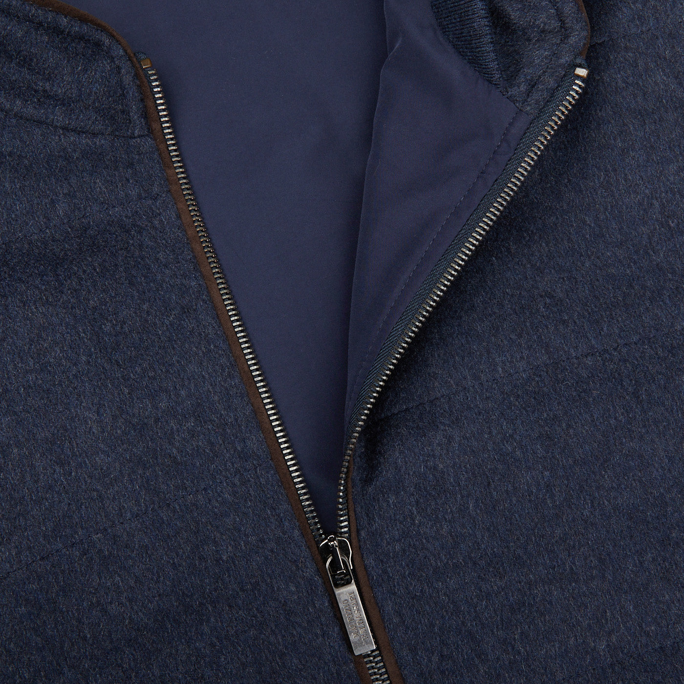 A close up of a Maurizio Baldassari Denim Blue Water Repellent Pure Cashmere Gilet with a zipper.