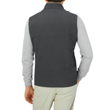 The back view of a man wearing a Maurizio Baldassari Charcoal Grey Merino Wool Travel Gilet.