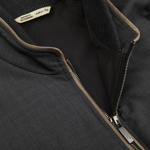 A close up of a Maurizio Baldassari Charcoal Grey Merino Wool Travel Gilet with a zipper made from cashmere.