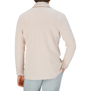 A person wearing a Maurizio Baldassari light beige, silk-cotton blend turtleneck sweater, viewed from the back.