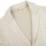 A close up of a Light Brown Cotton Mouline Swacket by Maurizio Baldassari on a white surface.