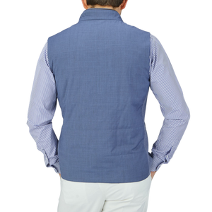 The back view of a man wearing a Maurizio Baldassari Light Blue Merino Wool Travel Gilet.