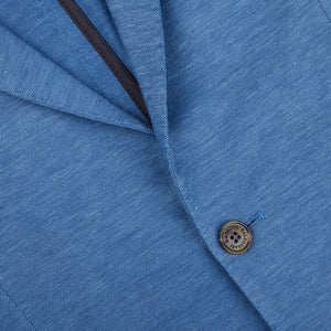 A Maurizio Baldassari light blue wool linen silk jersey blazer, suitable for both seasonal casual occasions, crafted with a blend of wool and silk and featuring buttons.