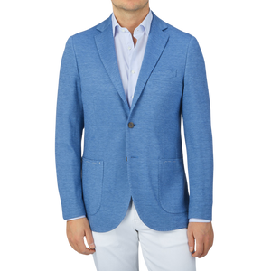 A man wearing a Maurizio Baldassari Light Blue Wool Linen Silk Jersey Blazer and white pants.