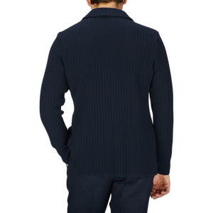 The back view of a man wearing a Maurizio Baldassari Navy Blue Organic Cotton Rib Stitched Swacket.