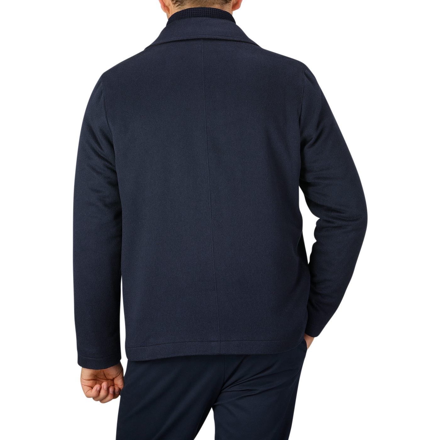 A person is seen from behind, wearing a Maurizio Baldassari Navy Cashmere Half Padded Chore Coat and dark blue pants against a plain gray background.