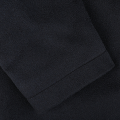 Close-up of the navy long-sleeve garment sleeve, showcasing the luxurious cashmere fabric texture and seam, revealing its high-quality craftsmanship akin to the Maurizio Baldassari Navy Cashmere Half Padded Chore Coat.