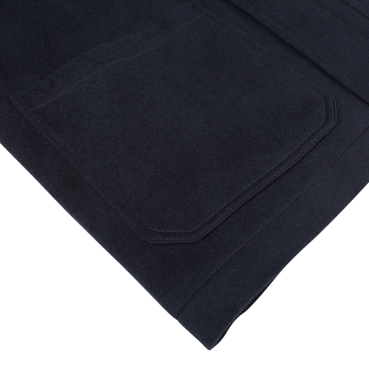 Close-up of a navy blue fabric with a pocket from the Maurizio Baldassari Navy Cashmere Half Padded Chore Coat, showcasing fine stitching and texture details, placed on a white background.